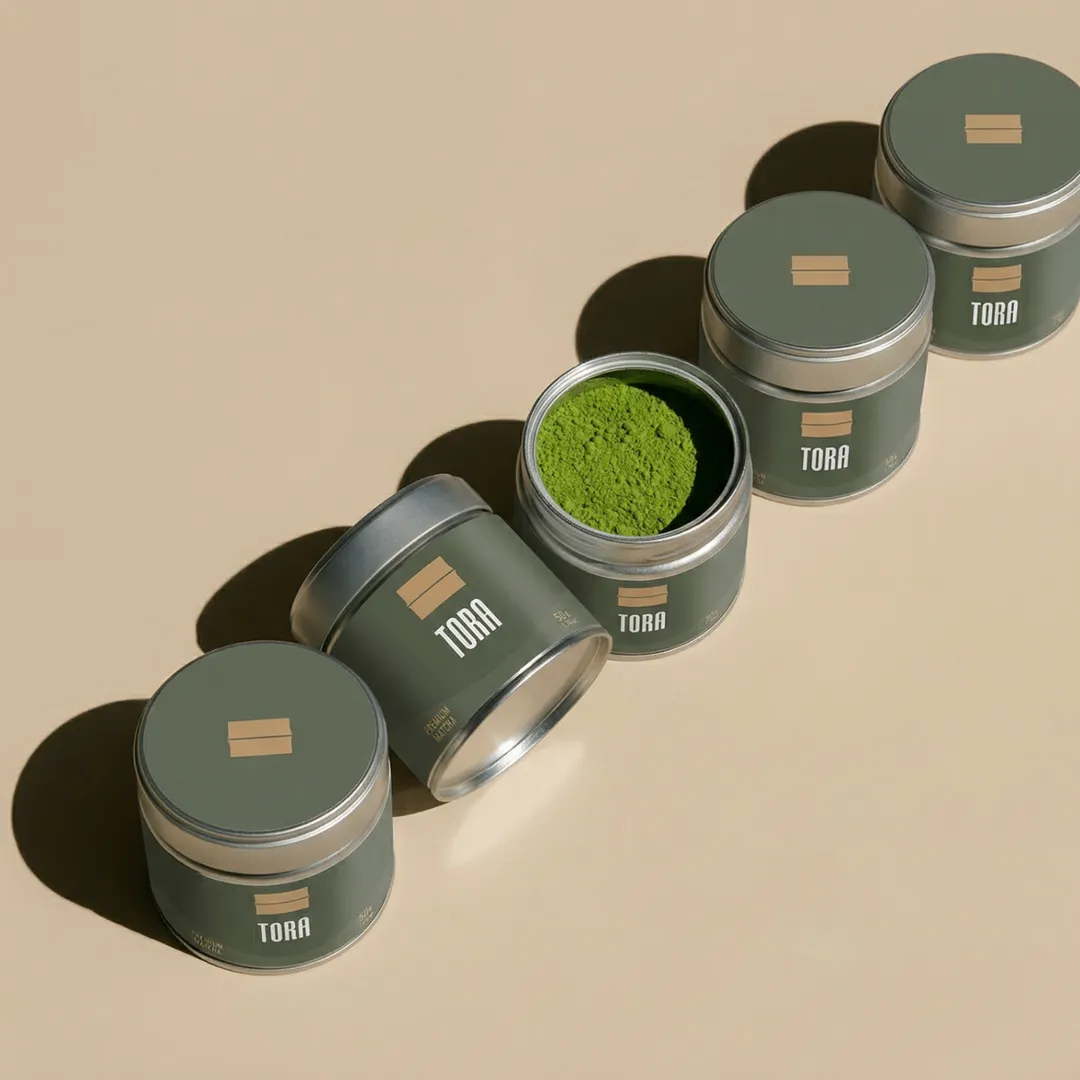 A matcha-green vessel and stone-ground tea in soft daylight